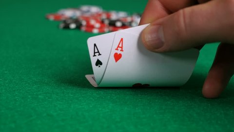 Poker Player with Pocket Aces Considers His Move As Attention Shifts From Cards To Chips