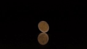 Two euro coin spinning on black background in slow motion - Powered by Shutterstock - Get 15% off with code: PIKWIZARD15