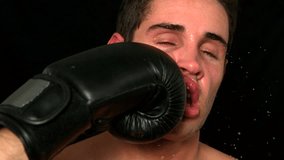 Portrait of tough Caucasian boxer taking a punch to the face in slow motion - Powered by Shutterstock - Get 15% off with code: PIKWIZARD15