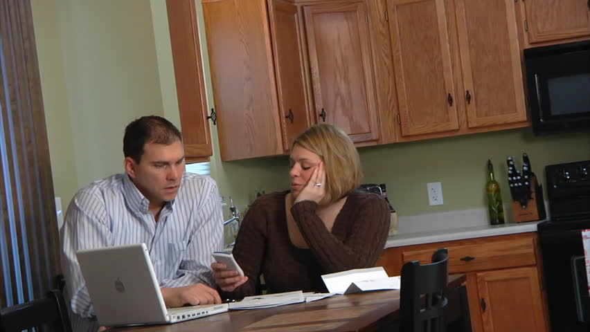 A husband and wife distressed over bills.
