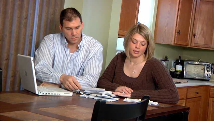 A husband and wife distressed over bills.