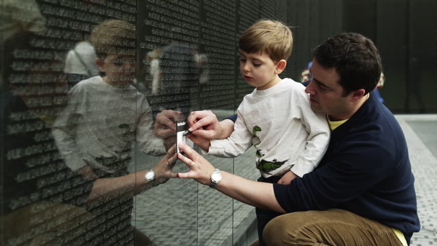 Medium Shot Father and son (4-5) at Memorial Wall, Vietnam Veterans Memorial, Washington D.C, USA