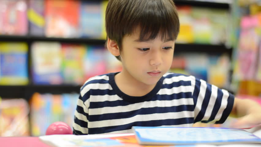 Little boy reading a book 