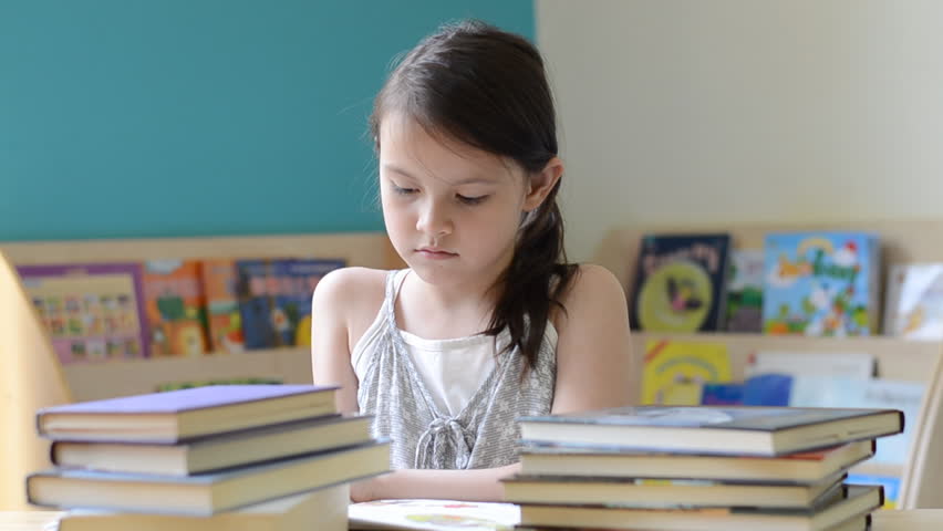 Little girl reading a book
