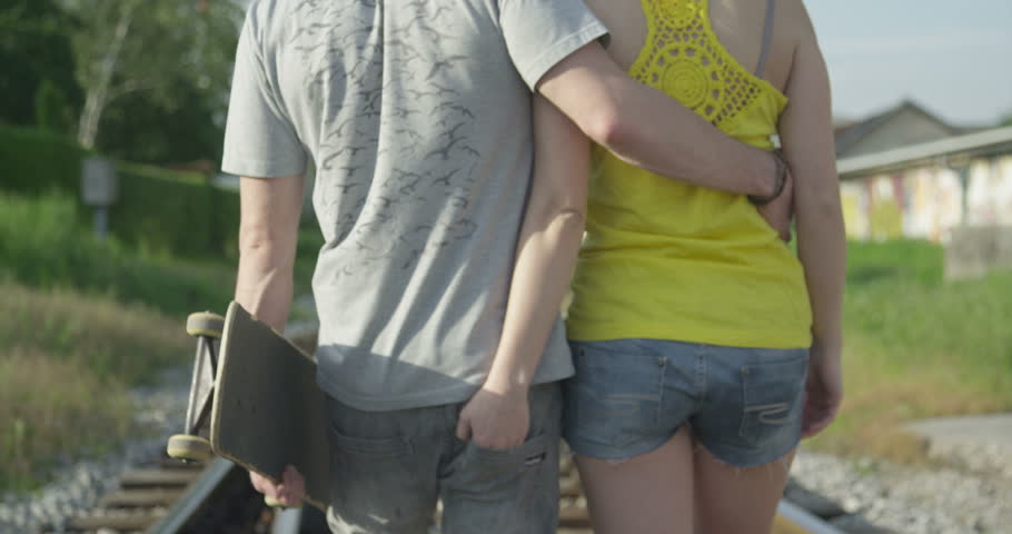 SLOW MOTION: Young couple in love walking on railroad tracks | Shutterstock HD Video #6347297