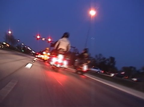 High speed clip of motorcycles at night.