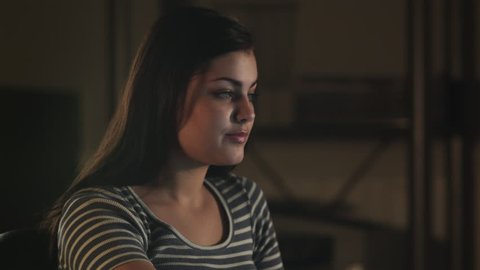Close Up Pan Teenage girl (16-17) using laptop, eating carrots 