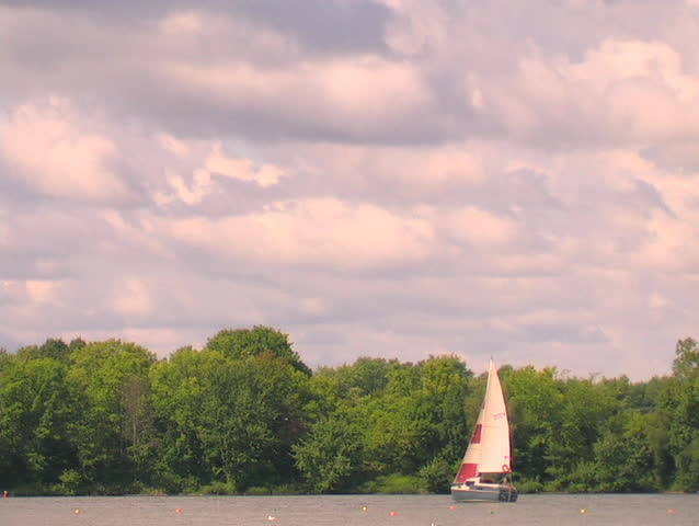 A SAILBOAT MAKING ITS WAY ACROSS FANSHAWE LAKE IN SOUTHWESTERN ONTARIO CANADA.