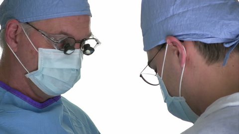 Two surgeons working together in front of a white background