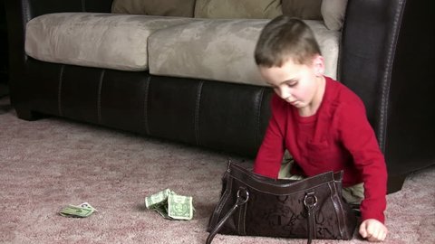 Kid pulls money out a purse, scoops it all up and throws it in the air.