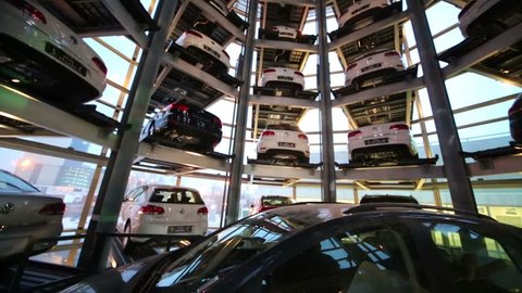 MOSCOW, RUSSIA - JAN 11, 2013: Falling elevator with car in center of tower to store cars in Volkswagen Center Varshavka at evening. Tower was designed and built in 2009.