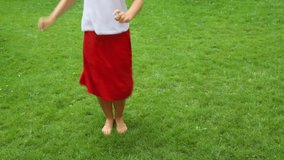 video of a woman waist down dancing barefoot on the grass 