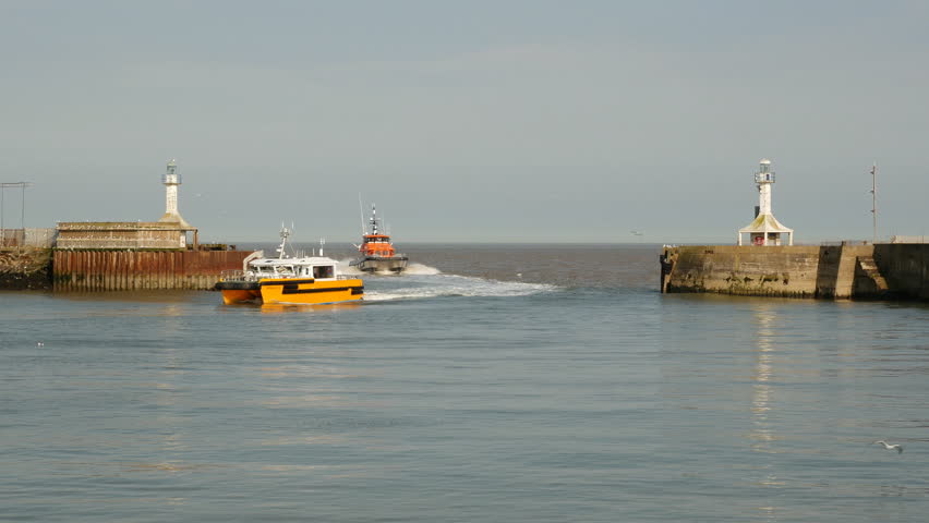 Lowestoft, England - May 2014. High Speed Wind Farm Support Vessels returning to harbour, Lowestoft harbour Entrance, Suffolk, England, United Kingdom