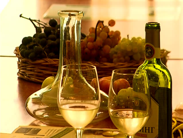 Wine,grapes,wine bottles and glasses arranged as a still life