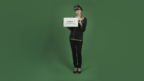 caucasian air hostess isolated on chroma green screen background election vote sign