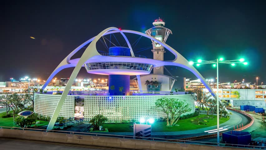 LOS ANGELES - CIRCA, 2014: Traffic around Theme Building housing Encounter restaurant in Los Angeles International Airport LAX at night. 4K Timelapse.