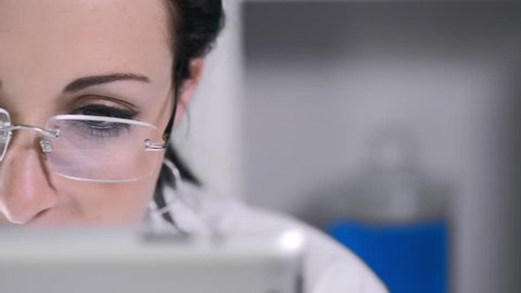 close up of lab technician using tablet computer