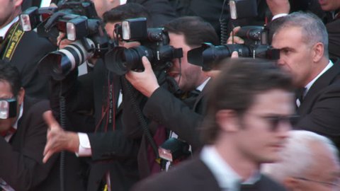 CANNES, FRANCE - MAY 2014: Photographers gesturing along the red carpet at the premiere of "Mr. Turner" at 67th Cannes Film Festival.