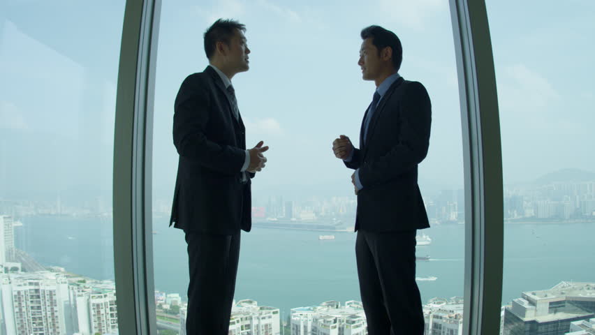 Young male Asian Chinese businessmen meeting modern skyscraper building boardroom silhouette cityscape background shot on RED EPIC | Shutterstock HD Video #6374420