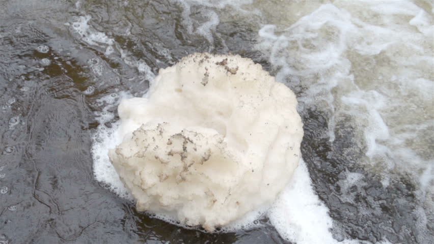 White bubbles created from water rapids on the river