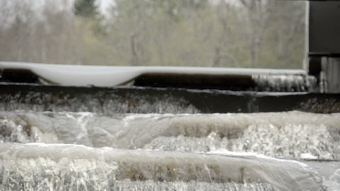 The rushing of water from a fish ladder or dam on a slow motion