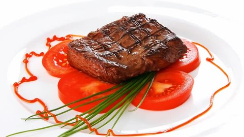 grilled beef meat entrecote fillet served with tomatoes and green chives china plate 1920x1080 intro motion slow hidef hd