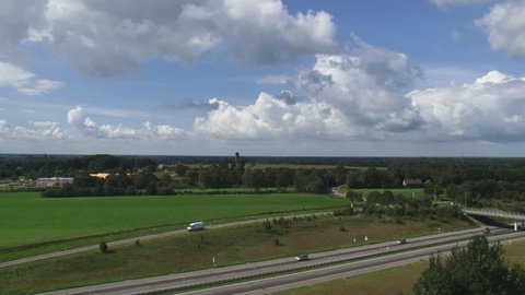 Traffic A32 highway in Dutch rural landscape + pan, taken from watchtower at Woldberg, The Netherlands.