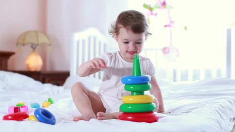 Toddler with the toy in nursery room 