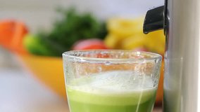squeezing vegetable green juice. cooking on a juicer