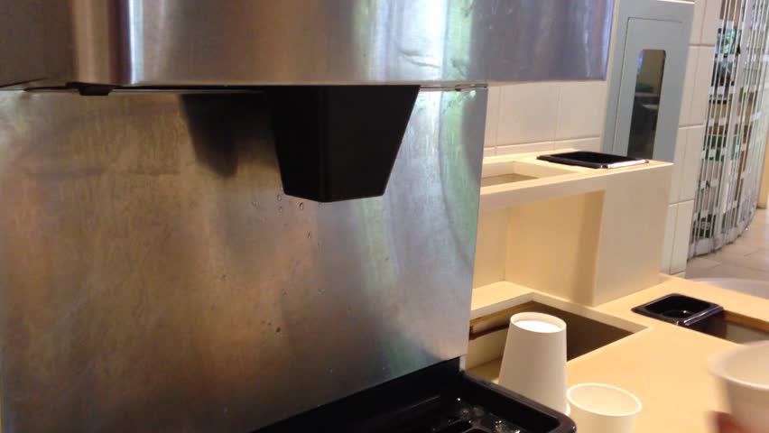 Filling ice to white cup inside school food court
