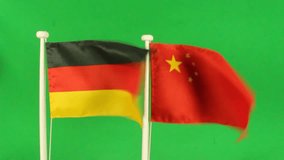 Flag of Germany and China, easy to isolate by chroma key. Real polyester flag on white wooden flag pole. No animation or slow motion.