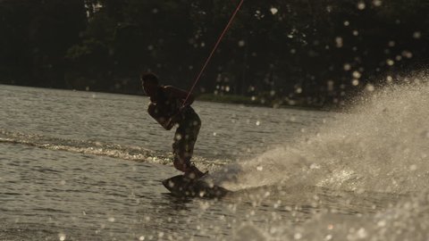 USA, Florida, Orlando, Maitland Lake. Young man on wakeboard