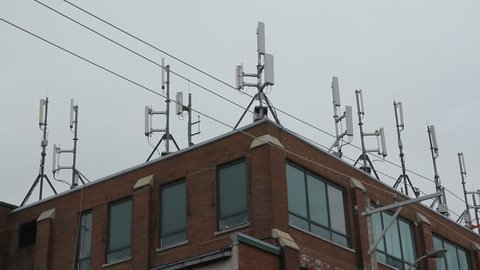 Cell site on commercial building. Seagull flies over.
Cellphone antennaes on commercial building in Toronto, Ontario, Canada. 