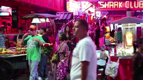 THAILAND, PATTAYA, MARCH 31, 2014: Walking Street is red-light district with many restaurants, go-go bars and brothels, that draws people, primarily for night life and sexual entertainments.
