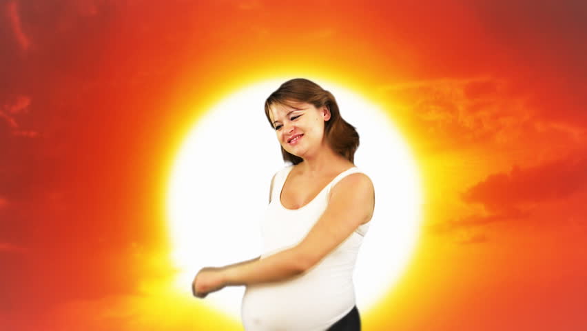 Pregnant woman dancing,sunset and colorful balloons