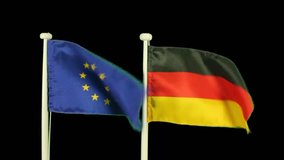 Flag of Europe and Germany isolated by chroma key. Real polyester flag on white wooden flag pole. No animation or slow motion.