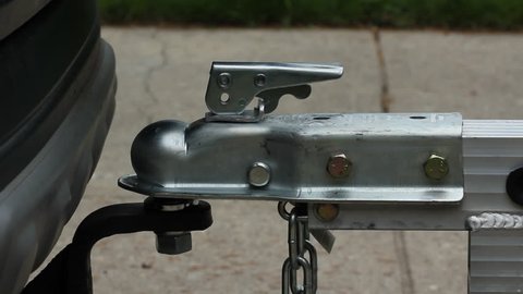 Putting trailer on ball hitch.
Lifting trailer on ball hitch and securing locking device.
