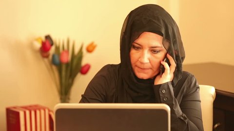 Muslim businesswoman talking on the phone