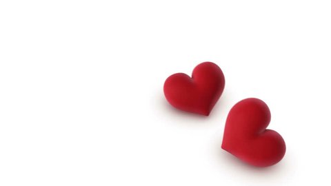 two hearts falling onto a white background - 3d animation