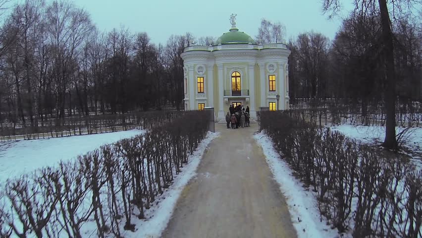 Tourist stand near entrance Aviary in museum-estate Kuskovo at winter evening. Aerial view