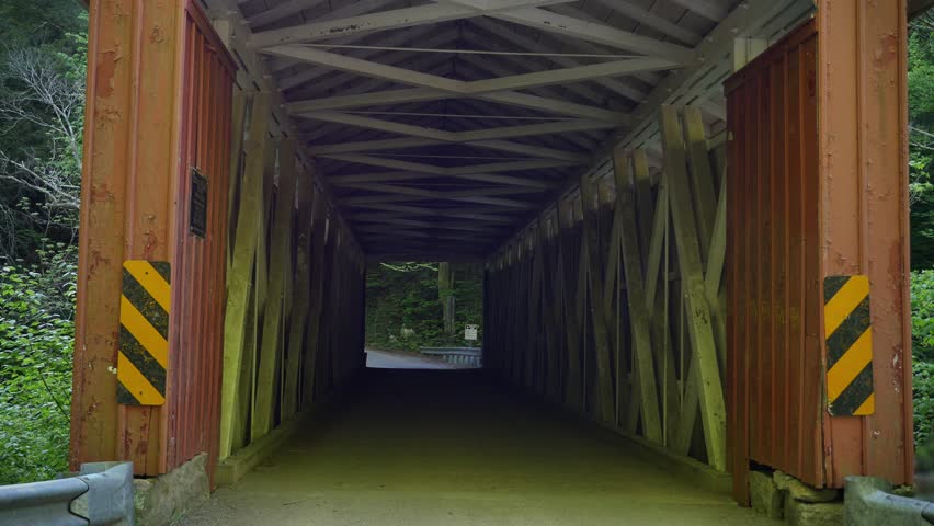 Cars pass over the covered bridge in McConnell