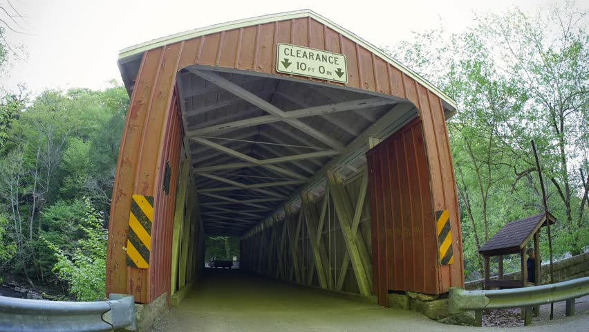 Cars pass over the covered bridge in McConnell
