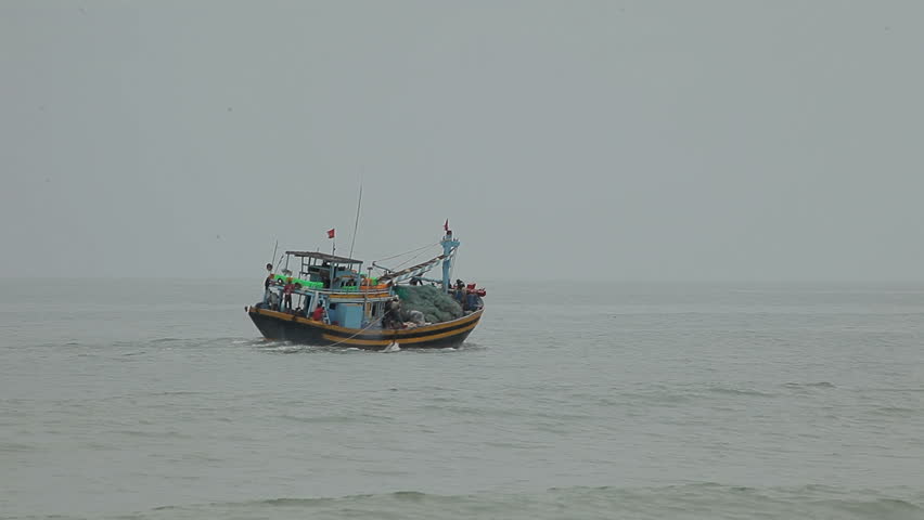 Traditional fishing boat on small waves. Vietnam.
