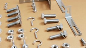 A wide variety of fasteners, spread on paper 