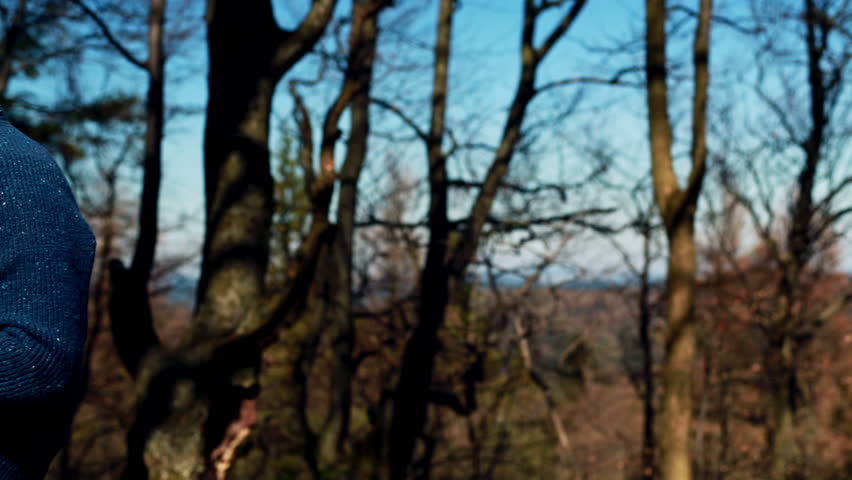 man working on a laptop and sitting in the forest

