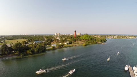 Aerial of a busy Inlet at sunset with the Jupiter Florida Lighthouse. 