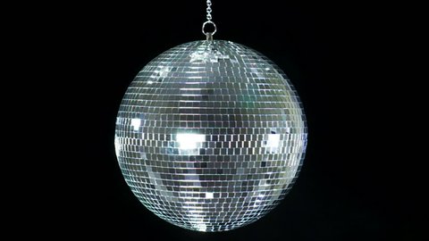 Mirror ball reflects white light. Disco ball with reflected moving rays. Loop.
