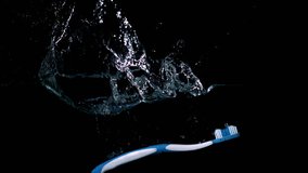 Blue toothbrush falling in water on black background in slow motion - Powered by Shutterstock - Get 15% off with code: PIKWIZARD15