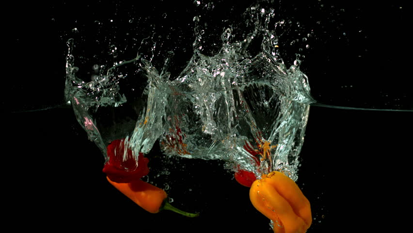 Chili peppers falling in water on black background in slow motion - Powered by Shutterstock - Get 15% off with code: PIKWIZARD15