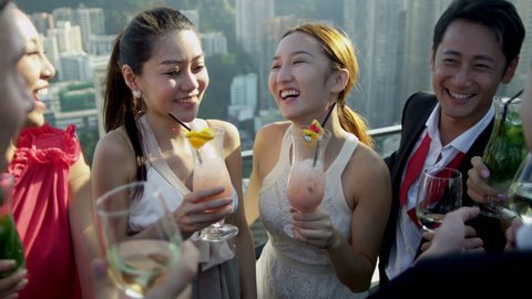 Group young male female multi ethnic advertising managers meeting evening cocktails rooftop bar modern cityscape background shot on RED EPIC 库存视频